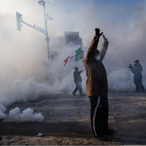 A person holds up their hands as law enforcement deploys a thick screen of teargas on Nicollet Avenue in Minneapolis on Saturday, Jan. 24, 2026. (Ben Hovland/Minnesota Public Radio via AP)