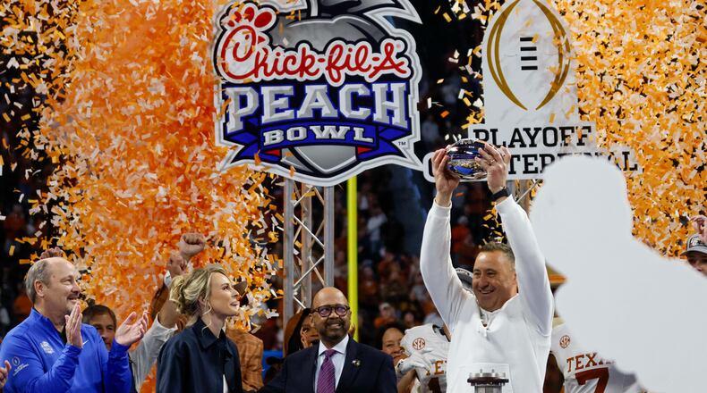 Texas Longhorn head coach Steve Sarkisian holds the trophy as they celebrate after defeating the Arizona State Sun Devils 39-31 in double overtime at the Chick-fil-A Peach Bowl held at Mercedes-Benz Stadium on Wednesday, January 1, 2025, in Atlanta.
(Miguel Martinez / AJC)
