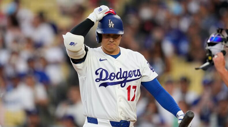Los Angeles Dodgers' Shohei Ohtani walks back to the dugout after striking out as during the third inning of a baseball game against the Cincinnati Reds, Monday, Sept. 7, 2026, in Los Angeles. (AP Photo/Mark J. Terrill)