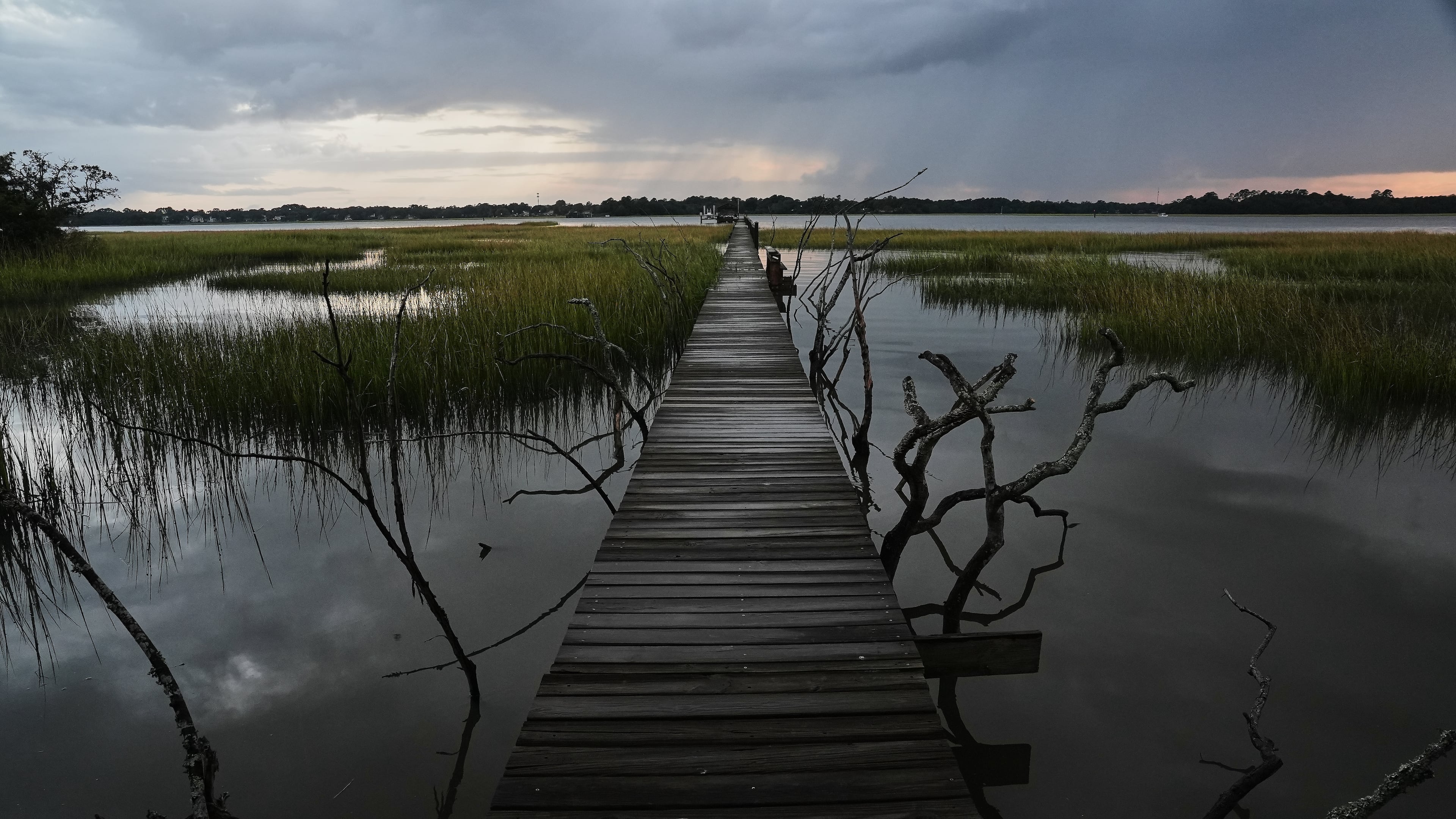A storm moves through a salt marsh at sunset Monday, Oct. 6, 2025, in Charleston, S.C. (AP Photo/Joshua A. Bickel)