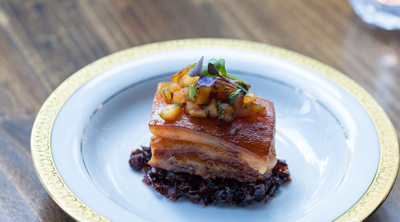 A succulent slab of pork belly, served in a nest of tart, balsamic-glazed cabbage, at the Consulate. (Contributed)