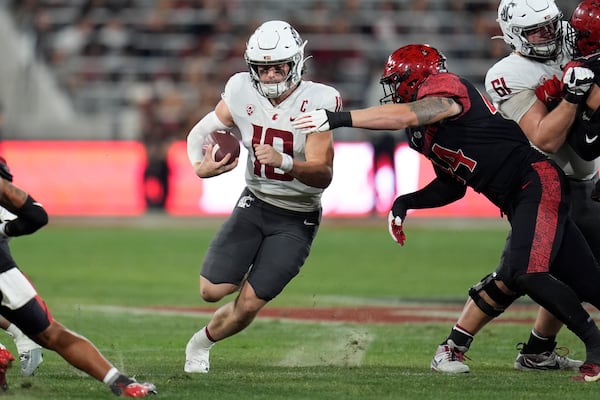 FILE - Washington State quarterback John Mateer runs with the ball during the first half of an NCAA college football game against San Diego State, Oct. 26, 2024, in San Diego. (AP Photo/Gregory Bull, File)
