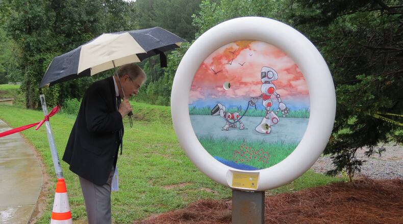 Peachtree Corners recently unveiled the first of six round shaped Button Art sculptures. The first sculpture features a friendly looking robot walking a robotic dog, a nod to the high-tech businesses in Technology Park. (Courtesy City of Peachtree Corners)