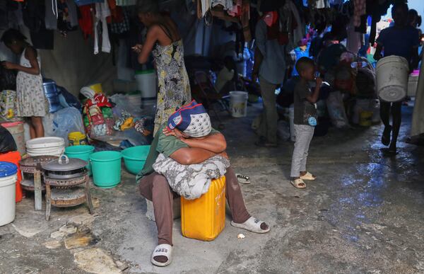 A displaced woman rests at a school that is now operating as a shelter for those fleeing their homes to escape gang violence in Port-au-Prince, Haiti, Monday, April 14, 2025. (AP Photo/Odelyn Joseph)