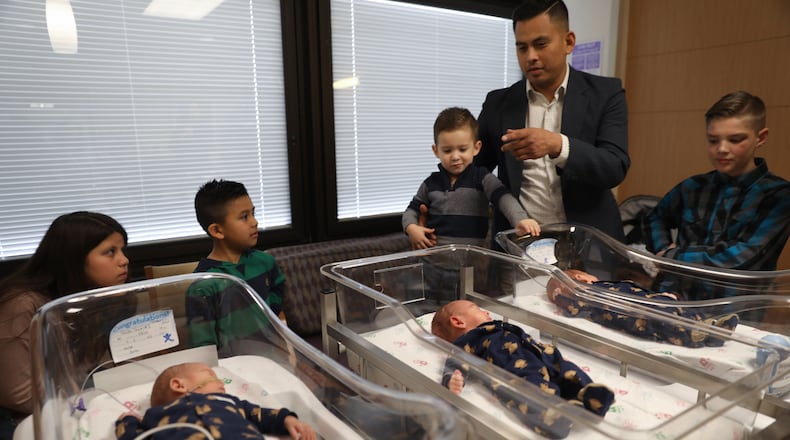 Mario Aguirre and Teri Nobles introduce their triplets, Vincent Alan, front left, Santino Michael, center, and his identical brother Andres Lionel, and their four older siblings, in the back, from left, Brooklynn Aguirre, 11, Mateo Aguirre, 8, twin Marcel Chance Aguirre, 3, and Logan Benson, 10, during an interview at Advocate Good Samaritan Hospital Friday March 30, 2018 in Downer’s Grove, Ill. Contributed byAbel Uribe/Chicago Tribune/TNS