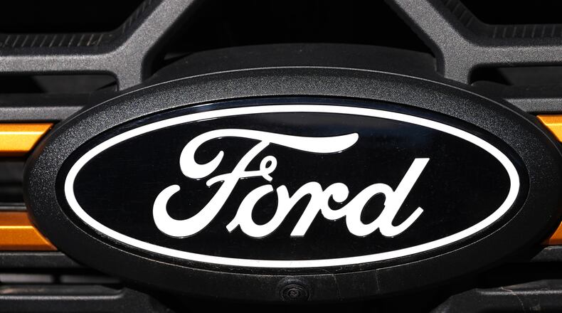 FILE - A Ford logo is seen on the grille of an unsold vehicle at a Ford dealership, Nov. 2, 2025, in Littleton, Colo. (AP Photo/David Zalubowski, File)