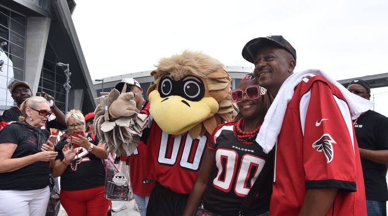 Freddie Falcon, seen here posing with fans at a game in 2017, will be at Chapel Hill Middle School to encourage an active lifestyle as part of the NFL’s Fuel Up to Play 60 program. HYOSUB SHIN / HSHIN@AJC.COM