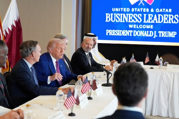 President Donald Trump speaks, seated between Kelly Ortberg President and CEO of Boeing, left, and Larry Culp, CEo of GE Aerospace during a business roundtable, Thursday, May 15, 2025, in Doha, Qatar. (AP Photo/Alex Brandon)