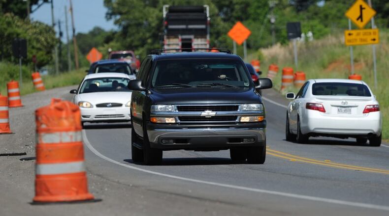 Johns Creek will work with the Georgia Department of Transportation to obtain land needed to widen Abbotts Bridge Road. AJC FILE