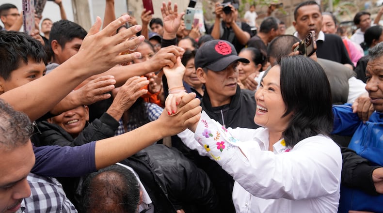 Presidential candidate Keiko Fujimori, of the Popular Force party, greets supporters before voting in the presidential runoff election in Lima, Peru, Sunday, June 7, 2026. (AP Photo/Martin Mejia)