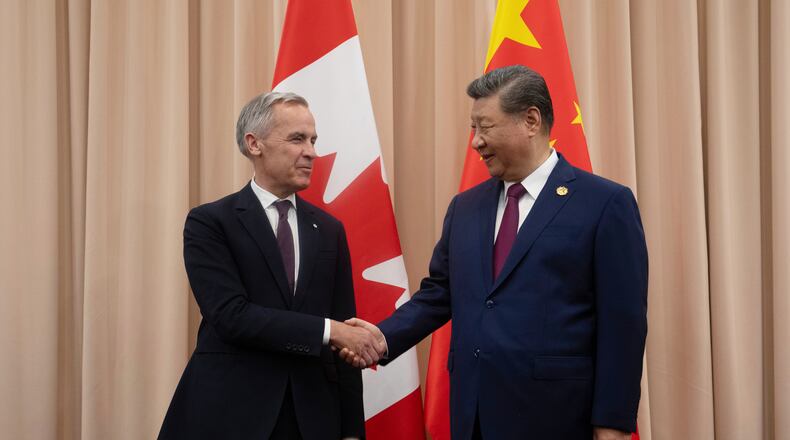 FILE - Canadian Prime Minister Mark Carney, left, shakes hands with Chinese President Xi Jinping at the start of a meeting in Gyeongju, South Korea, Oct. 31, 2025. (Adrian Wyld/The Canadian Press via AP, File)