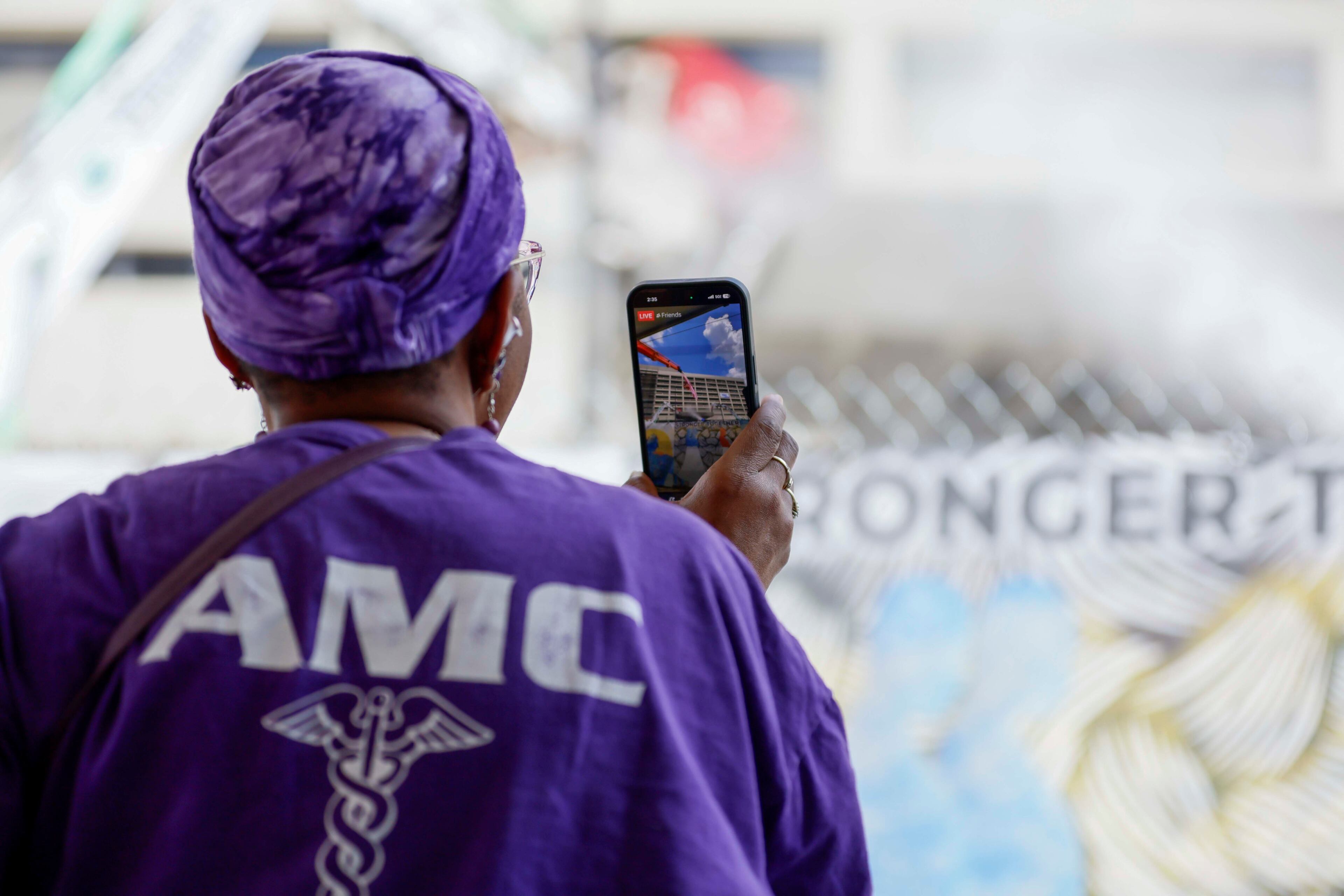 Former Atlanta Medical Center administrator secretary Meta Anthony records a video as heavy equipment begins demolishing the site, marking the start of the project's transformation into a new phase on Monday, June 30, 2025. The AMC served the surrounding communities for over a century.
(Miguel Martinez/ AJC)