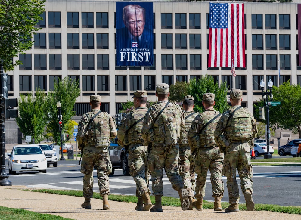 In Washington, National Guard soldiers recently patrolled the area near the Labor Department, where a poster of President Donald Trump was visible.