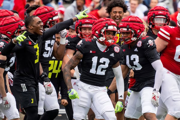 Nebraska defensive back Kahmir Prescott (12) celebrates with teammates after an interception during an NCAA college football practice Saturday, April 26, 2025, in Lincoln, Neb. (AP Photo/Dylan Widger)
