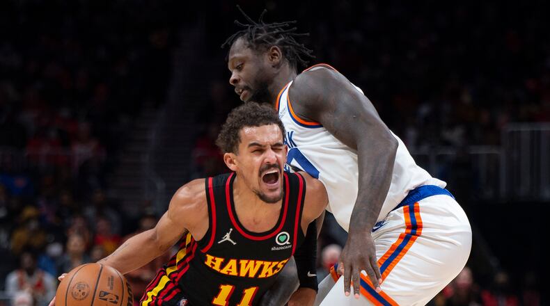 New York Knicks forward Julius Randle (30) defends Atlanta Hawks guard Trae Young (11) during the first half of an NBA basketball game Saturday, Nov. 27, 2021, in Atlanta. (AP Photo/Hakim Wright Sr.)