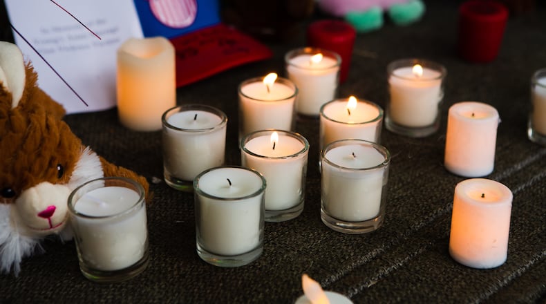 Candles sit in front of a memorial during a candlelight vigil on Thursday, March 18, 2021, in Acworth, Georgia, to honor the lives of Delaina Ashley Yaun, Paul Andre Michels, Xiaojie Tan and Daoyou Feng, who were shot and killed in spas around Acworth, Georgia, and others who were killed in similar shootings in Atlanta, on Tuesday, March 16, 2021. Six of the eight total victims were Asian women. CHRISTINA MATACOTTA FOR THE ATLANTA JOURNAL-CONSTITUTION.