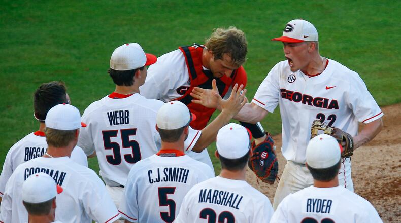 Georgia pitcher Aaron Schunk (22) celebrates with teammates after they defeated Arkansas 3-1 in a Southeastern Conference tournament NCAA college baseball game Thursday, May 23, 2019, in Hoover, Ala. (AP Photo/Butch Dill)