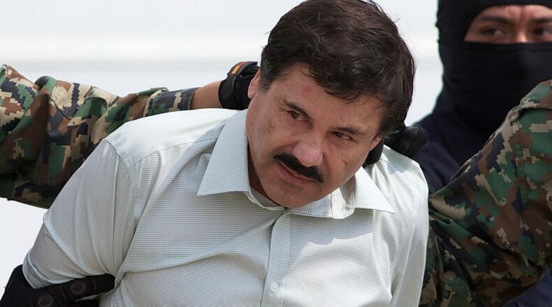 In this Feb. 22, 2014, file photo, Joaquin "El Chapo" Guzman, head of Mexico’s Sinaloa Cartel, is escorted to a helicopter in Mexico City, following his capture overnight in the beach resort town of Mazatlan. Mexico’s security commission said in a statement July 11, 2015, that Guzman has escaped from a maximum security prison, the second time he has fled after being captured.