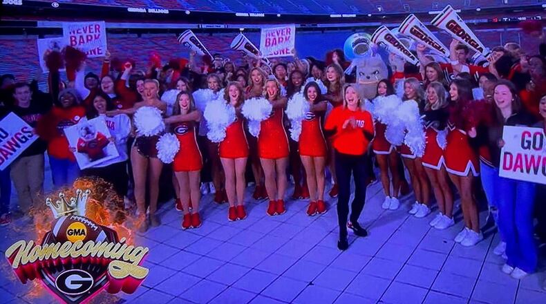 Good Morning America co-host Amy Robach, front in red and black, joins University of Georgia cheerleaders to celebrate the school's 100th homecoming anniversary on Oct. 14, 2022 outside Sanford Stadium. Robach is a 1995 UGA graduate. Image Credit: ABC News.