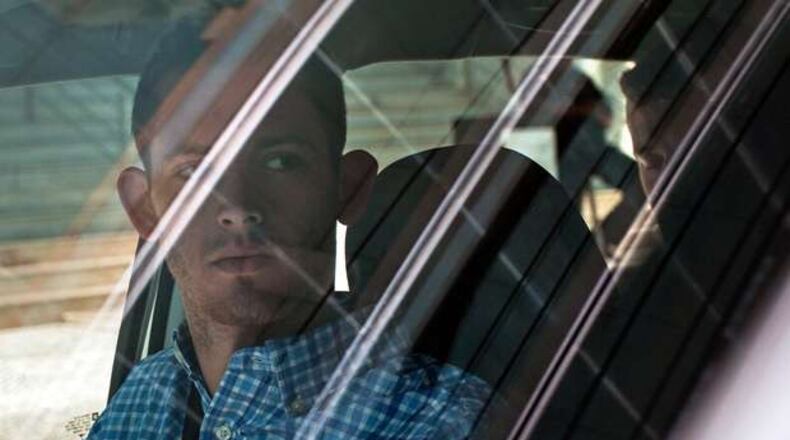 American Olympic swimmers Gunnar Bentz, left, and Jack Conger, in backseat, sit inside a car outside a police station where they were going to provide testimony in Rio de Janeiro, Thursday, Aug. 18, 2016. The two were taken off their flight from Brazil to the U.S. on Wednesday by local authorities amid an investigation into a reported robbery targeting Ryan Lochte and his teammates. A Brazilian police official is telling The Associated Press that American swimmer Lochte fabricated a story about being robbed at gunpoint in Rio de Janeiro. T(AP Photo/Mauro Pimentel)