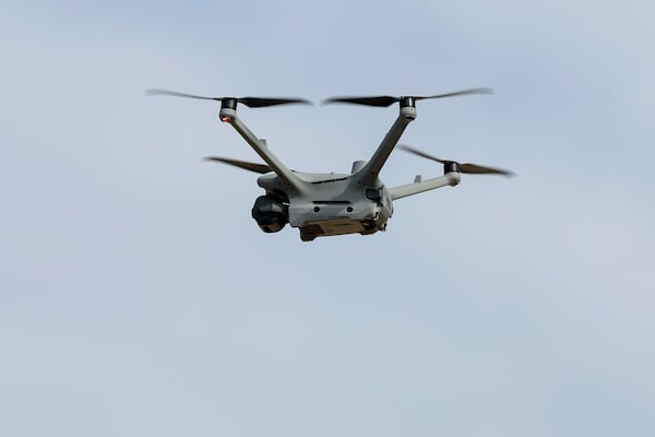 A drone flies from the roof of the Fulton County Jail on Thursday. It's purpose is to spot other drones dropping cigarettes, food and other contraband to open windows. (Jason Getz/AJC)