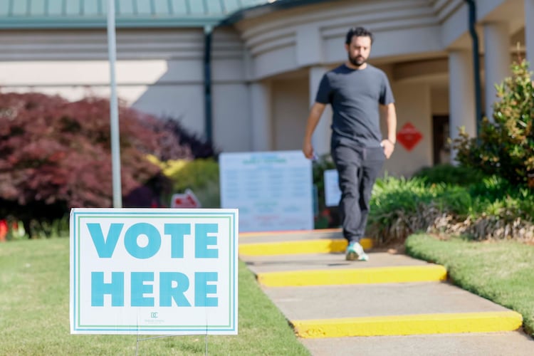 A man walks past a voting sign during the first day of early voting for the primary elections at the Dunwoody Library on Monday, April 27, 2026. (Miguel Martinez/AJC)