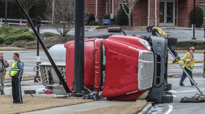 A Gwinnett County day care and two gas stations were evacuated Tuesday morning after a gasoline tanker crashed in an intersection, spilling fuel onto the road.