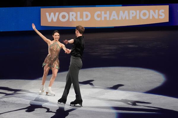 Gold medalists Madison Chock and Evan Bates, of the United States, celebrate during a medal ceremony for ice dancing at the figure skating world championships, Saturday, March 29, 2025, in Boston. (AP Photo/Charles Krupa)