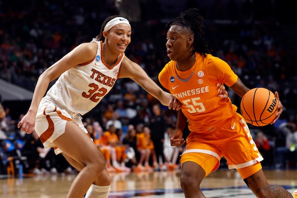Tennessee guard Talaysia Cooper (55) dribbles around Texas guard Ndjakalenga Mwenentanda (32) as she drives to the basket during the first half in the Sweet 16 of the NCAA college basketball tournament, Saturday, March 29, 2025, in Birmingham, Ala. (AP Photo/Butch Dill)