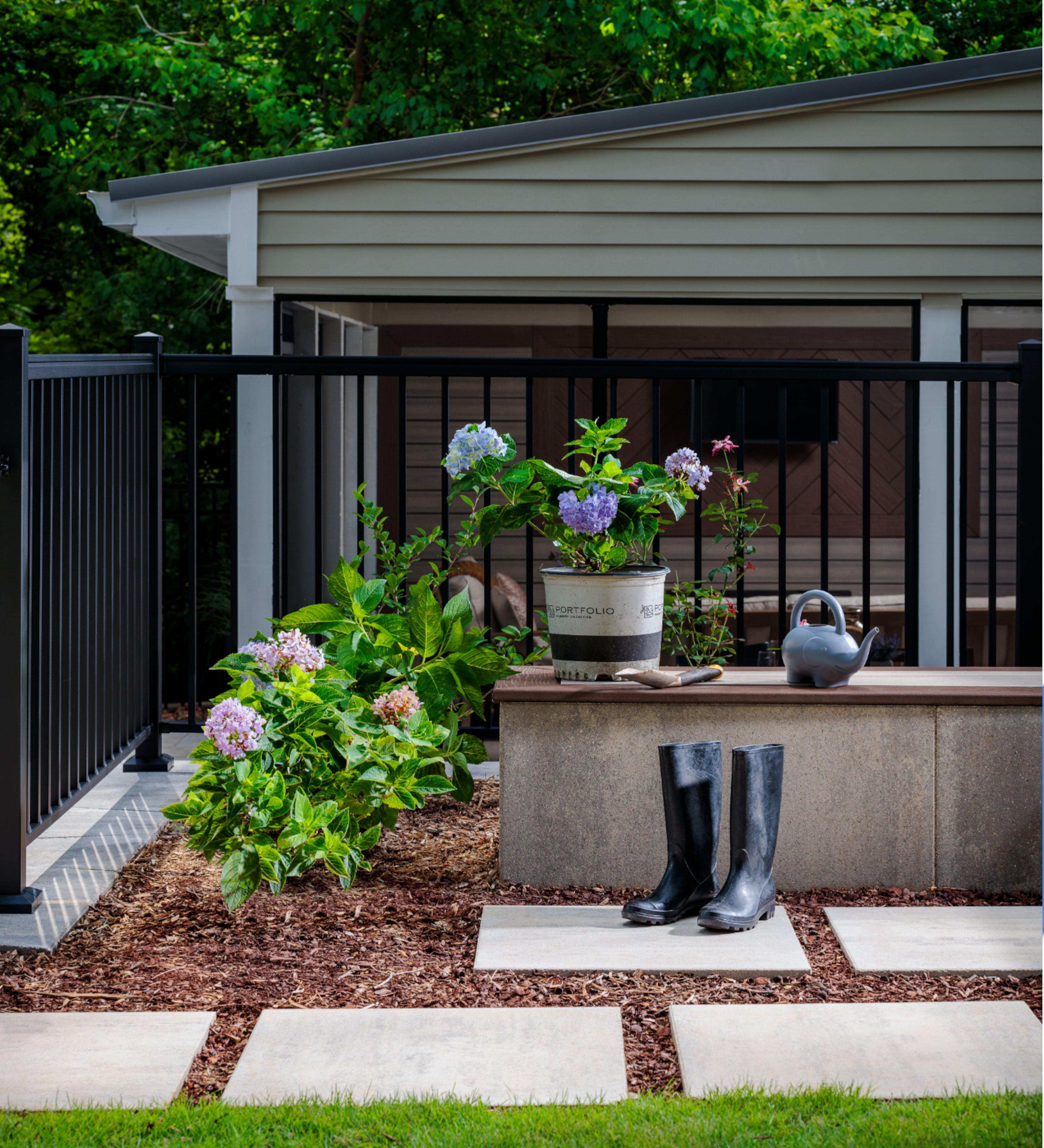 Whether it’s adding natural stone or creating a cozy nook with a sense of “prospect and refuge,” the goal is to make the outdoor experience feel calming and innate. Photo courtesy of Oldcastle APG.