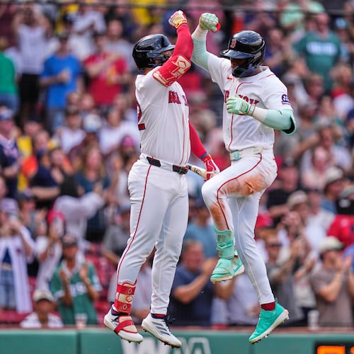 Boston Red Sox's Ceddanne Rafaela, right, is congratulated by Wilyer Abreu after hitting a solo home run in the fourth inning during the first baseball game of a doubleheader against the Baltimore Orioles, Wednesday, July 22, 2026, in Boston. (AP Photo/Charles Krupa)