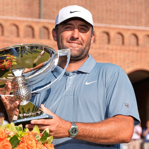 Scottie Scheffler holds the trophy after winning the PGA Tour Championship golf tournament Sunday, Aug. 30, 2026, in Atlanta. (AP Photo/Mike Stewart)