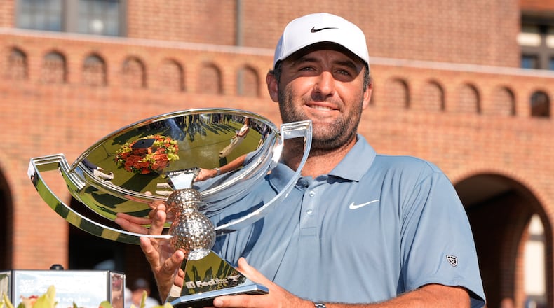Scottie Scheffler holds the trophy after winning the PGA Tour Championship golf tournament Sunday, Aug. 30, 2026, in Atlanta. (AP Photo/Mike Stewart)