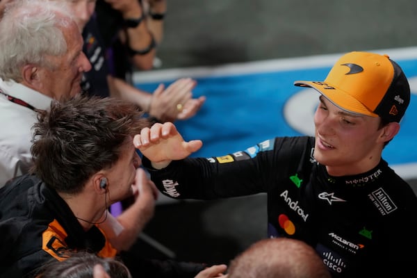 McLaren driver Oscar Piastri of Australia, right, celebrates with his team after winning the Formula One Saudi Arabian Grand Prix at the Jeddah Corniche Circuit in Jeddah, Saudi Arabia, Sunday, April 20, 2025. (AP Photo/Darko Bandic)