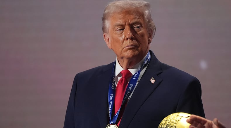 FILE - President Donald Trump stands on stage next to the FIFA World Cup after receiving the FIFA Peace Prize during the draw for the 2026 soccer World Cup at the Kennedy Center in Washington, Dec. 5, 2025. (AP Photo/Jacquelyn Martin, File)