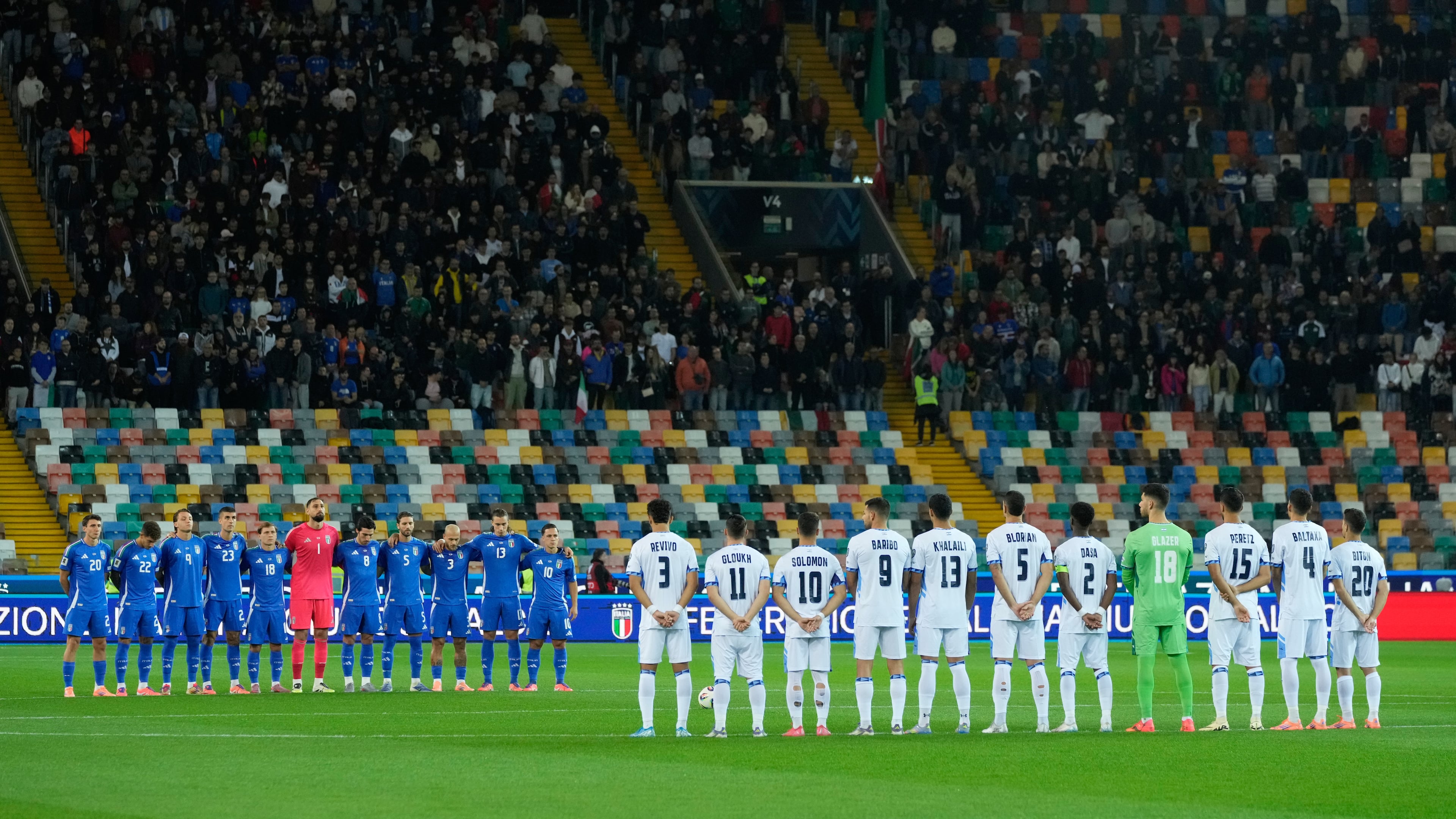 Italy's and Israel's players observe a minute of silence for the three military police officers Carabinieri dead in a explosion near Verona prior to the start of the World Cup 2026 Group I qualifying soccer match between Italy and Israel at the Bluenergy Stadium in Udine, Italy, Tuesday, Oct. 14, 2025. (AP Photo/Luca Bruno)