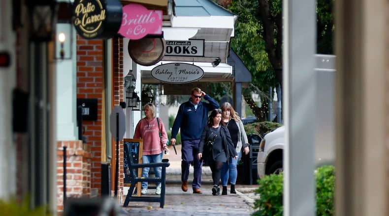 People on Carroll Street in downtown Perry in early February. The variety of businesses and shops is notable here, reflecting the ongoing revival of this 200-year-old city's historic downtown.
(Miguel Martinez/ AJC)