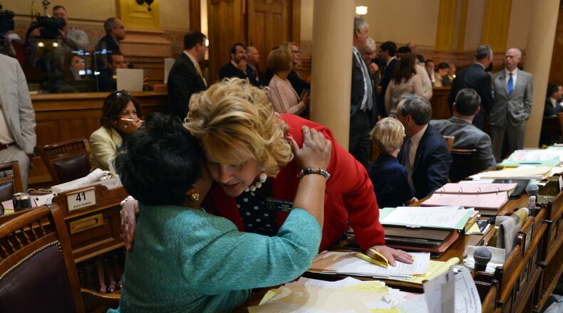 Sen. Renee Unterman (right) is congratulated by Sen. Gail Davenport after the Senate passed HB 885, which included amended language that mandated insurance companies cover autism treatments for kids. Unterman — chairwoman of the Senate Health and Human Services Committee — combined the autism bill with a bill to legalize medical marijuana late in the session under one bill she dubbed the “Kids Care Act.” It passed in the Senate but was blocked in the House.