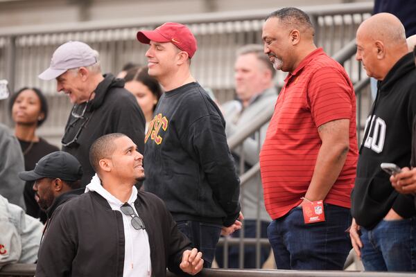 FILE - Chicago Bears general manager Ryan Poles, left, speaks with Carl Williams, father of Southern California quarterback Caleb Williams, second from right, at the school's NFL football pro day, Wednesday, March 20, 2024, in Los Angeles. (AP Photo/Ryan Sun, File)