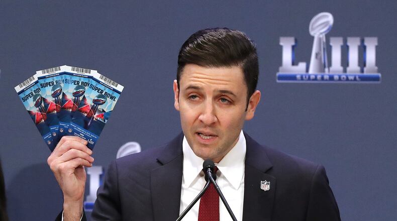 Michael Buchwald, NFL Senior Counsel, Legal, holds up real Super Bowl tickets during the National Football League and law enforcement agencies press conference announcing the latest results of seizures of counterfeit game-related merchandise and tickets during a press conference at the Georgia World Congress Center on Thursday, Jan. 31, 2019, in Atlanta.   Curtis Compton/ccompton@ajc.com