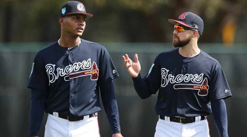 Ender Inciarte (right) gives some tips to Cristian Pache during a workout this week at Braves spring training in Lake Buena Vista, Fla. Curtis Compton/ccompton@ajc.com