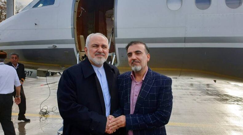 Iran's Foreign Minister Mohammad Javad Zarif , Zarif, left, shakes hands with Iranian scientist Massoud Soleimani prior to leaving Zurich, Switzerland, for Tehran, on Saturday. (Javad Zarif twitter account via AP)
