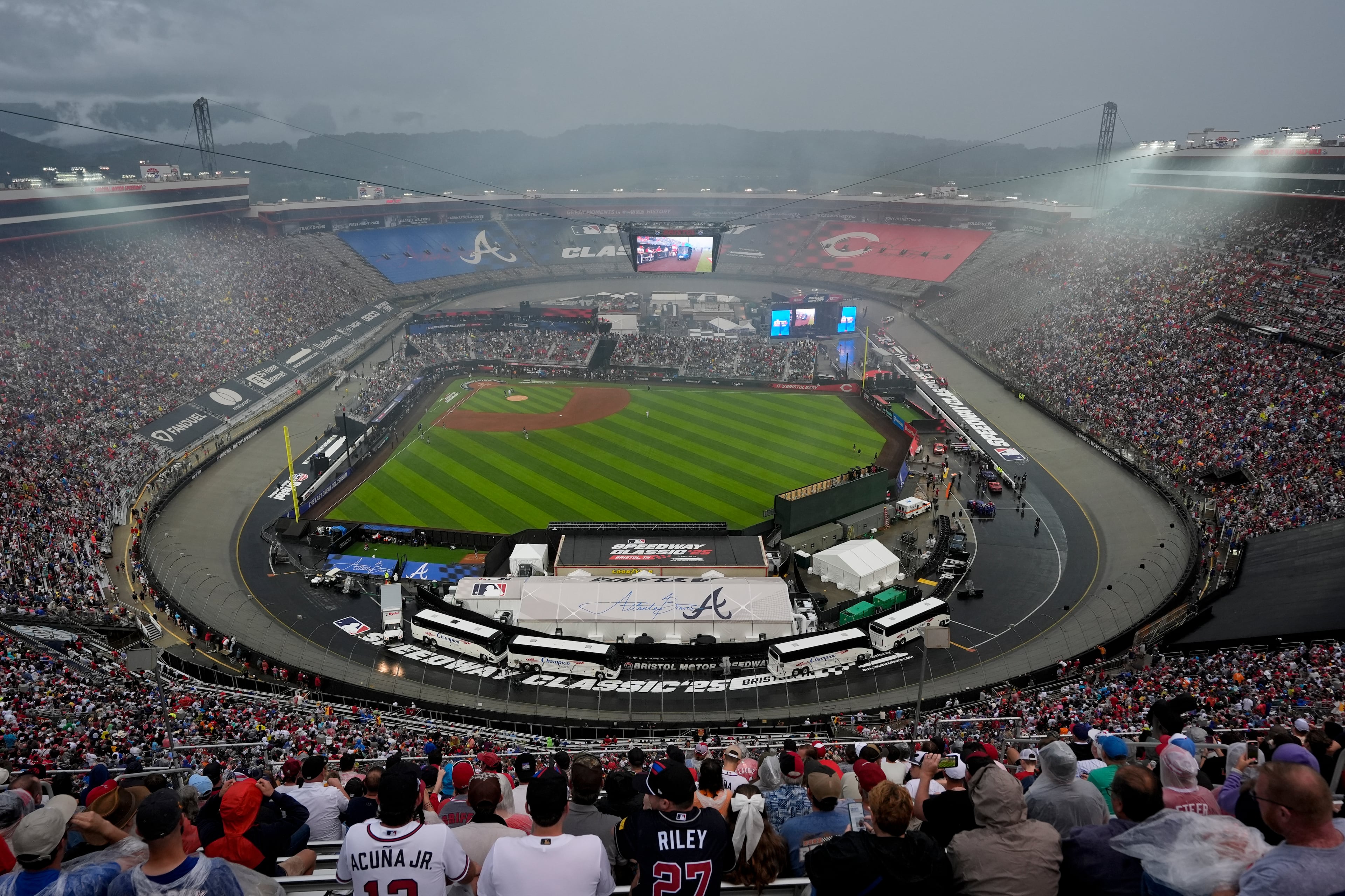 Fans wait for the start during a rain delay at the MLB Speedway Classic baseball game between the Atlanta Braves and the Cincinnati Reds at Bristol Motor Speedway in Bristol, Tenn., Saturday, Aug. 2, 2025. (AP Photo/George Walker IV)