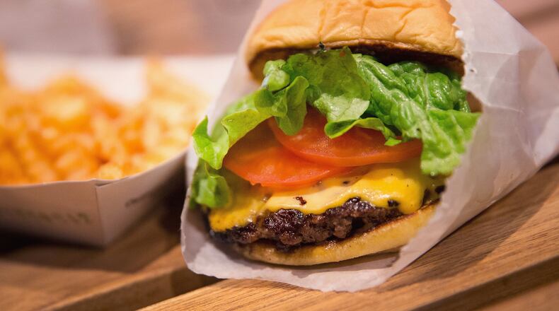 CHICAGO, IL - JANUARY 28:  In this photo illustration a cheeseburger and french fries are served up at a Shake Shack restaurant on January 28, 2015 in Chicago, Illinois. The burger chain, with currently has 63 locations, is expected to go public this week with an IPO priced between $17 to $19 a share. The company will trade on the New York Stock Exchange under the ticker symbol SHAK.  (Photo Illustration by Scott Olson/Getty Images)