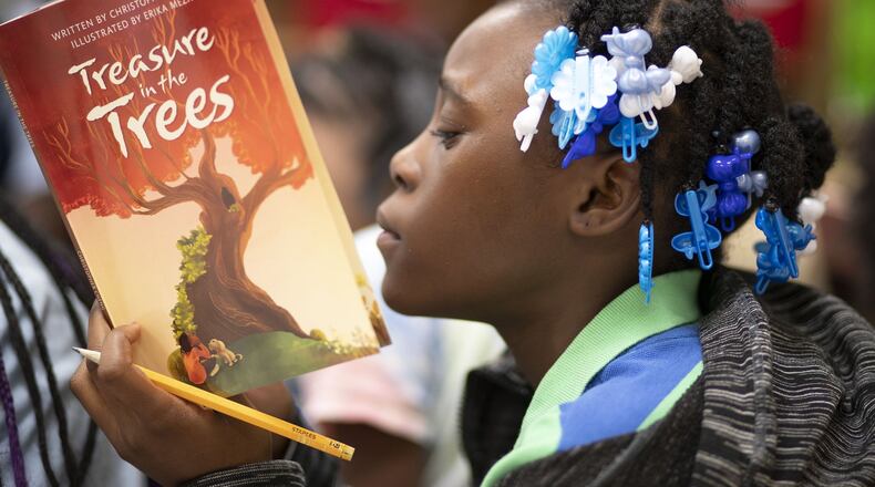 A student reads a book at Harper-Archer Elementary School. BOB ANDRES / robert.andres@ajc.com