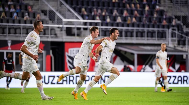 Atlanta United's Adam Jahn (from left), Jon Gallagher and Brooks Lennon celebrate a goal in 4-0 defeat of D.C. United Saturday, Oct. 4, 2020, in Washington, D.C.