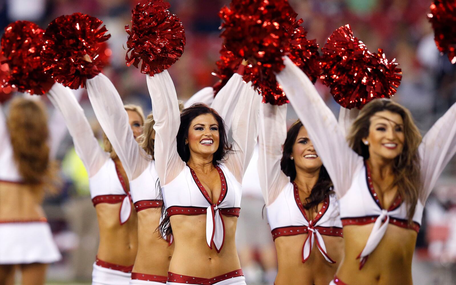 NFL cheerleaders perform at preseason games