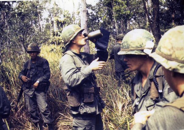 Max Cleland takes a drink while serving on a mission in Vietnam. Cleland overcame the loss of three limbs to serve in multiple roles in state and federal government, including leading the Veterans Administration. photo Courtesy of Stetson University, DuPont-Ball Library.