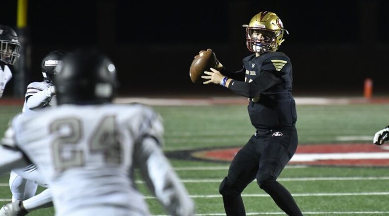Johns Creek QB Ben Whitlock looks to pass against Alpharetta during Friday's game. Johns Creek clinched Region 7-AAAAAA with the victor. (John Amis/Special)