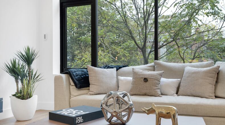 Pillows in the same neutral palette as the main upholestery piece helps create a minimal and fresh yet elegant look in this bright living room. (Design Recipes)